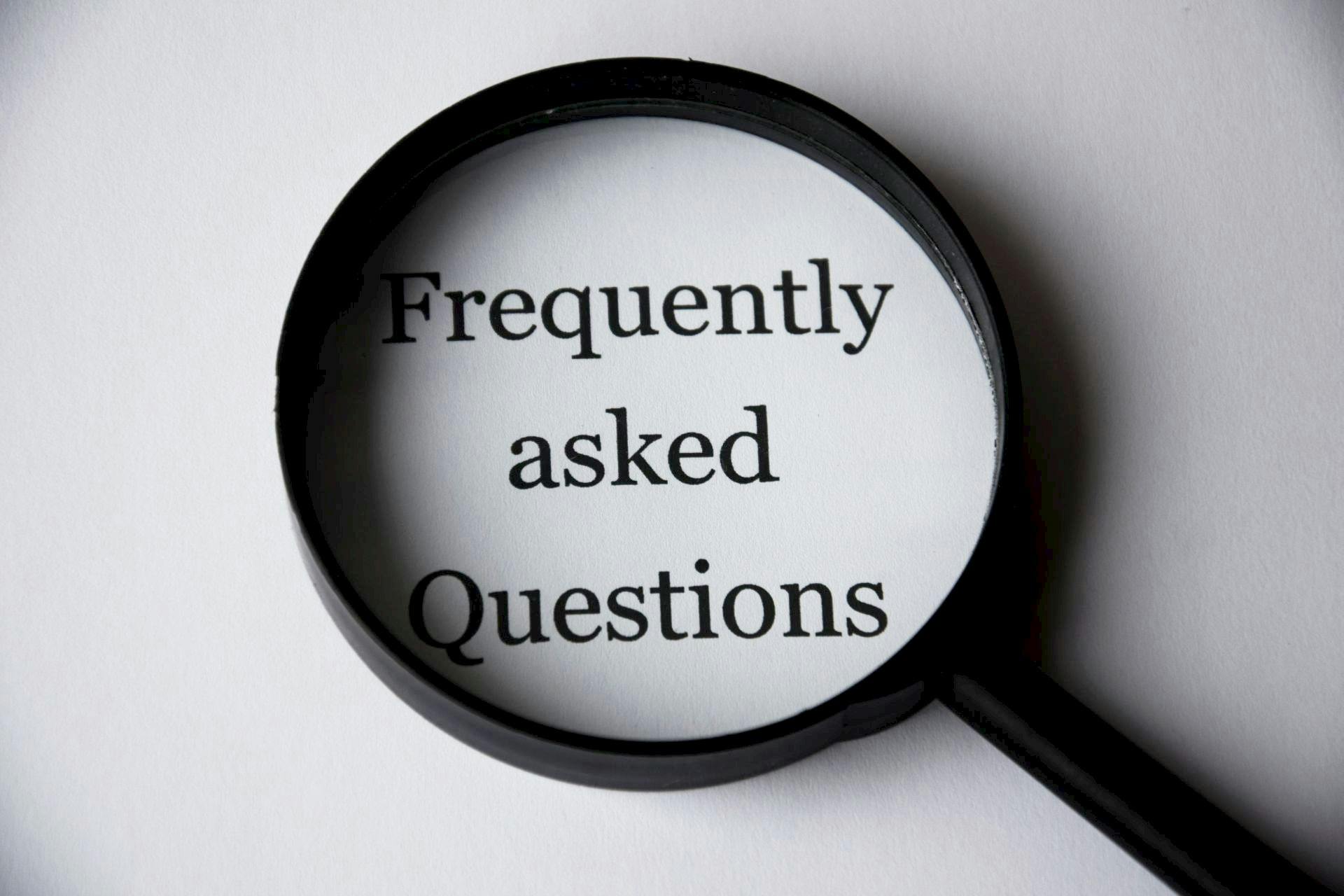 Magnifying Glass with text "Frequently asked Questions" underneath it